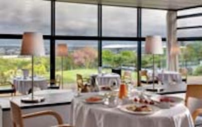 Le Saint James Bordeaux restaurant with large windows overlooking garden area