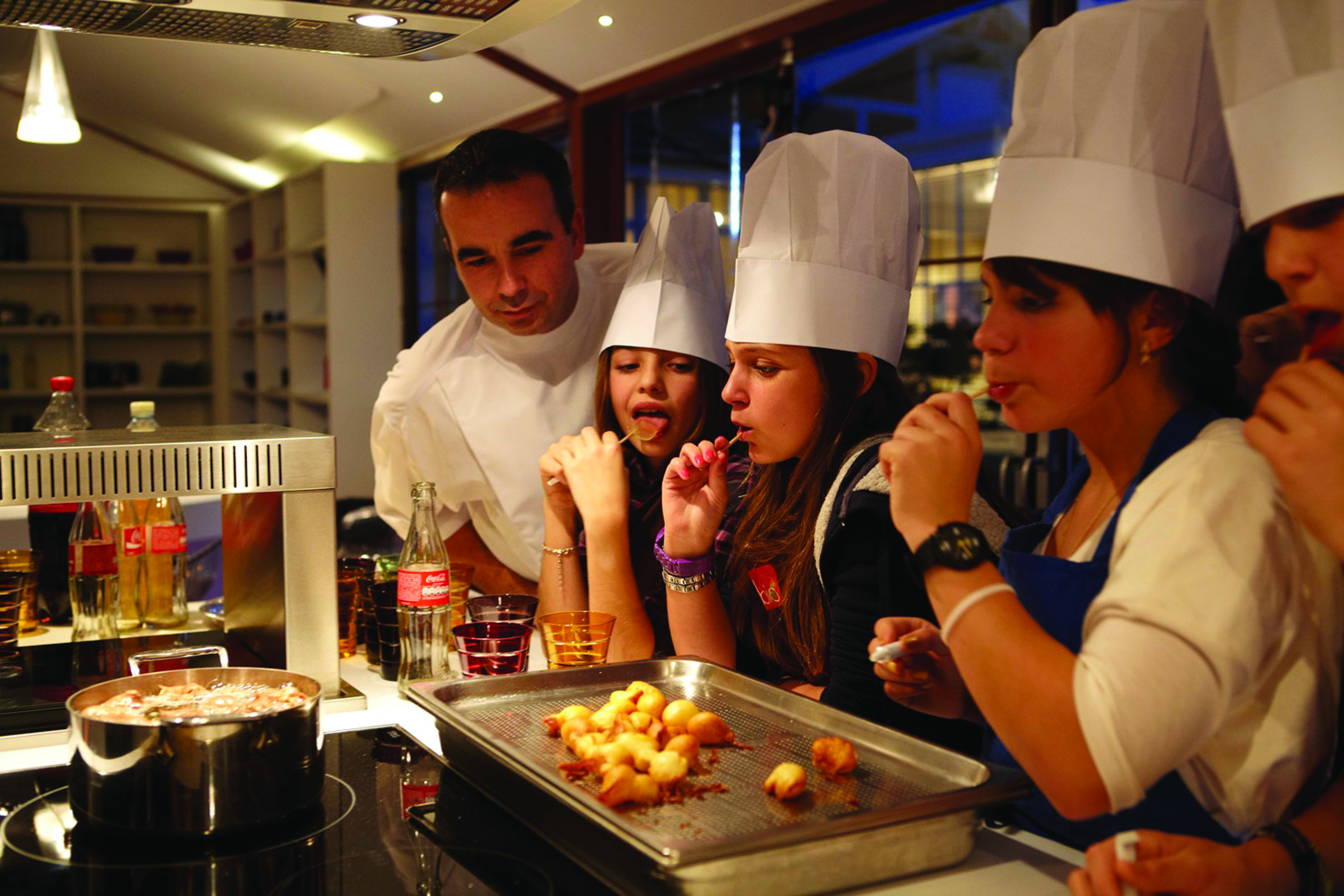 Cookery class with chef and pupils in chef hats