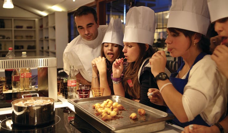 Cookery class with chef and pupils in chef hats