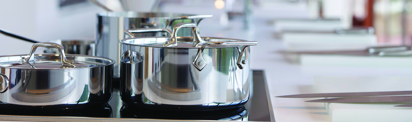 Silver pots on a hob for cookery lesson