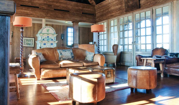 Wood pannelled lounge with old fashioned decor, leather sofas and a grand father clock