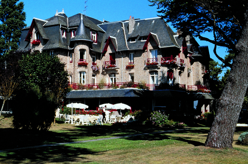 Castel Marie Louise Brittany exterior building with grey roof and view of gardens and outdoor dining area