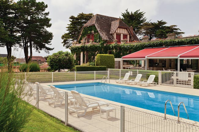 Hotel Hermitage Barriere Brittany exterior pool with loungers near an old building and a terrace area