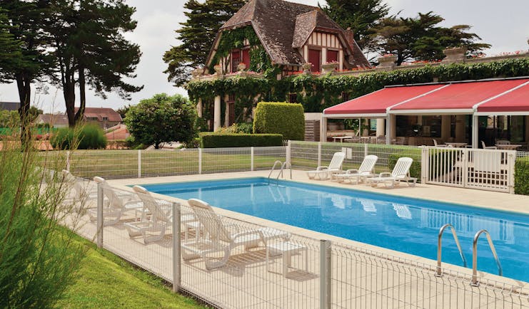 Hotel Hermitage Barriere Brittany exterior pool with loungers near an old building and a terrace area