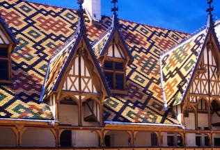 Multi coloured tiles of the roof of the Hospices in Beaune Burgundy