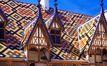 Multi coloured tiles of the roof of the Hospices in Beaune Burgundy