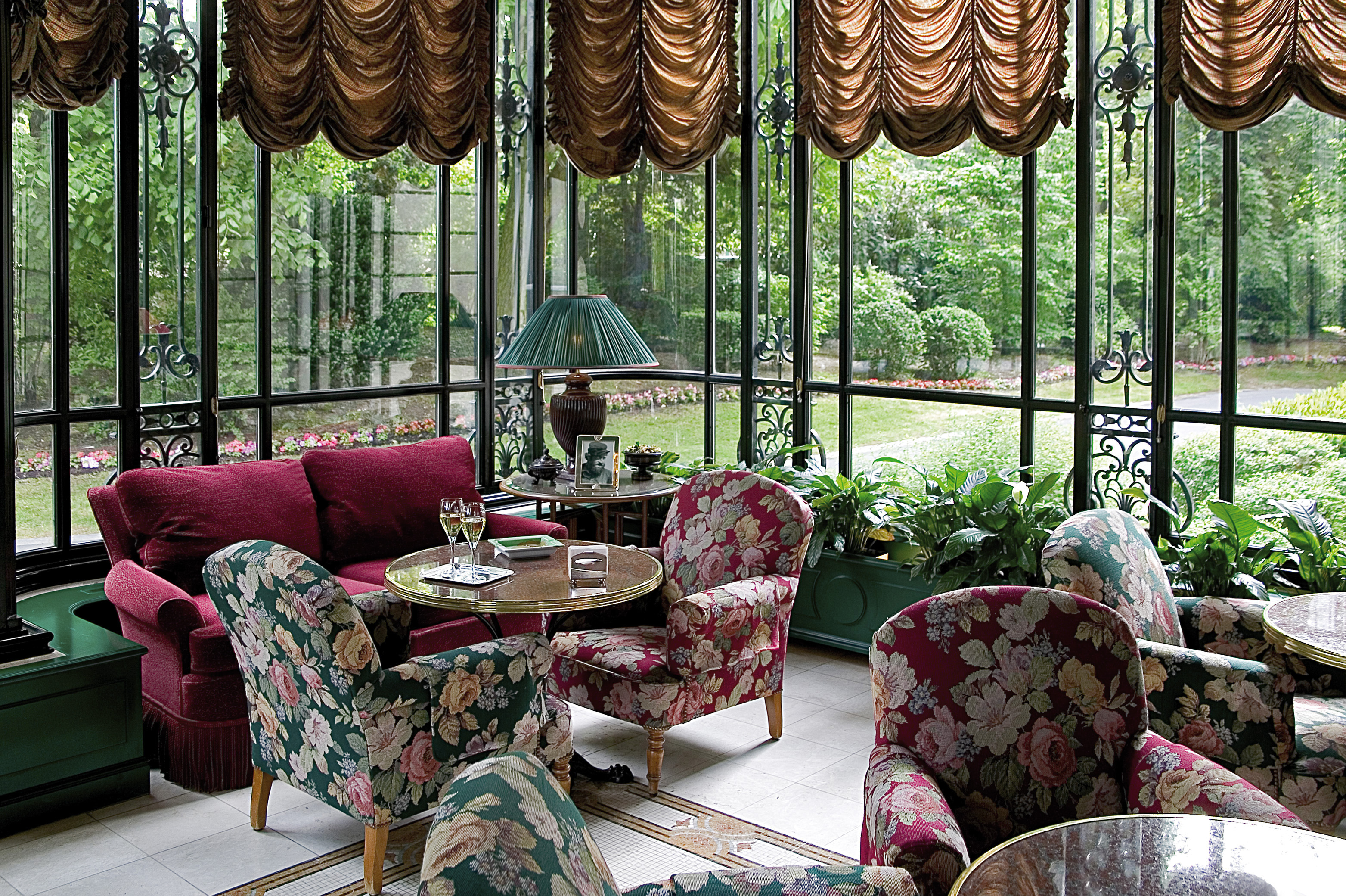 Lounge area with chairs and sofas looking over the gardens