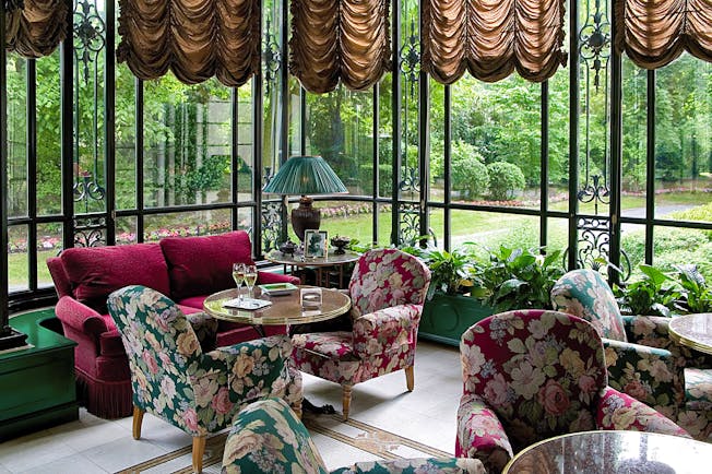 Lounge area with chairs and sofas looking over the gardens