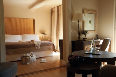 Grand Hotel de Cala Rossa Corsica junior suite bedroom with a large bed a desk and a table