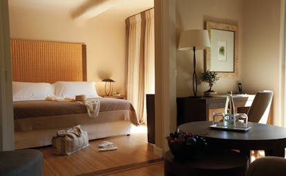Grand Hotel de Cala Rossa Corsica junior suite bedroom with a large bed a desk and a table