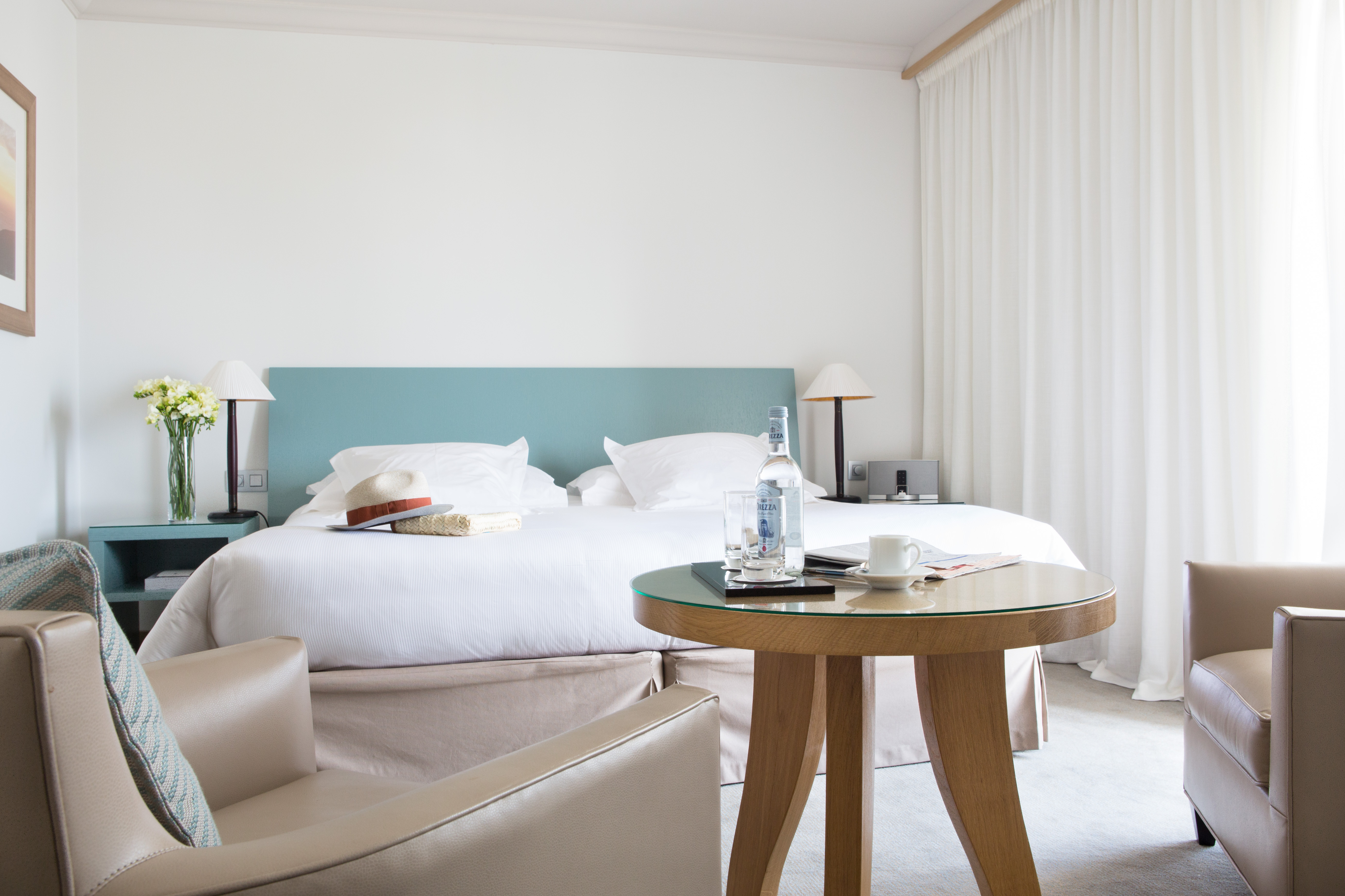 Bedroom with double bed, arm chair and coffee table
