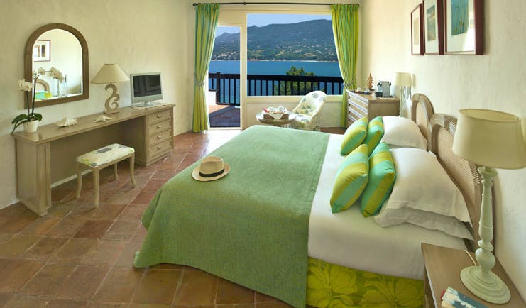 Miramar Boutique Hotel Corsica superior bedroom with tiled floors desk table chair and sea view