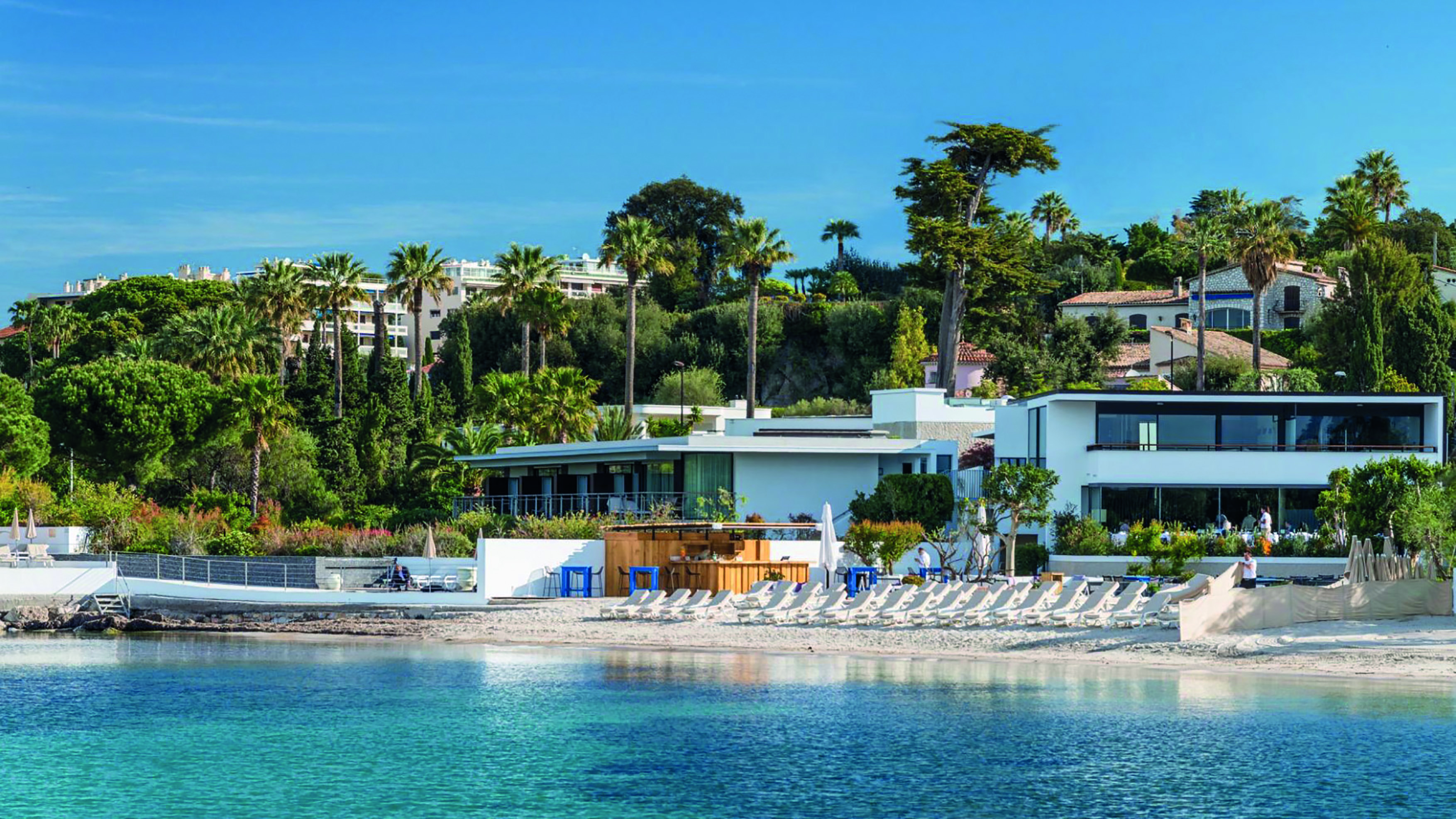Le Cap d'Antibes Beach Hotel Cote d'Azur beach outdoor sun loungers and umbrellas in front of a white building 