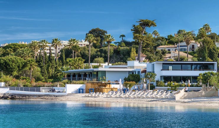Le Cap d'Antibes Beach Hotel Cote d'Azur beach outdoor sun loungers and umbrellas in front of a white building