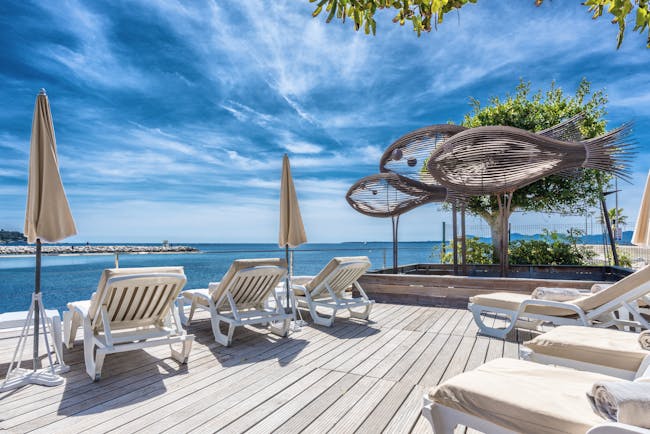 Le Cap d'Antibes Beach Hotel Cote d'Azur decking terrace sun loungers sculptures of fish
