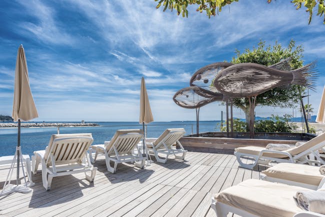 Le Cap d'Antibes Beach Hotel Cote d'Azur decking terrace sun loungers sculptures of fish