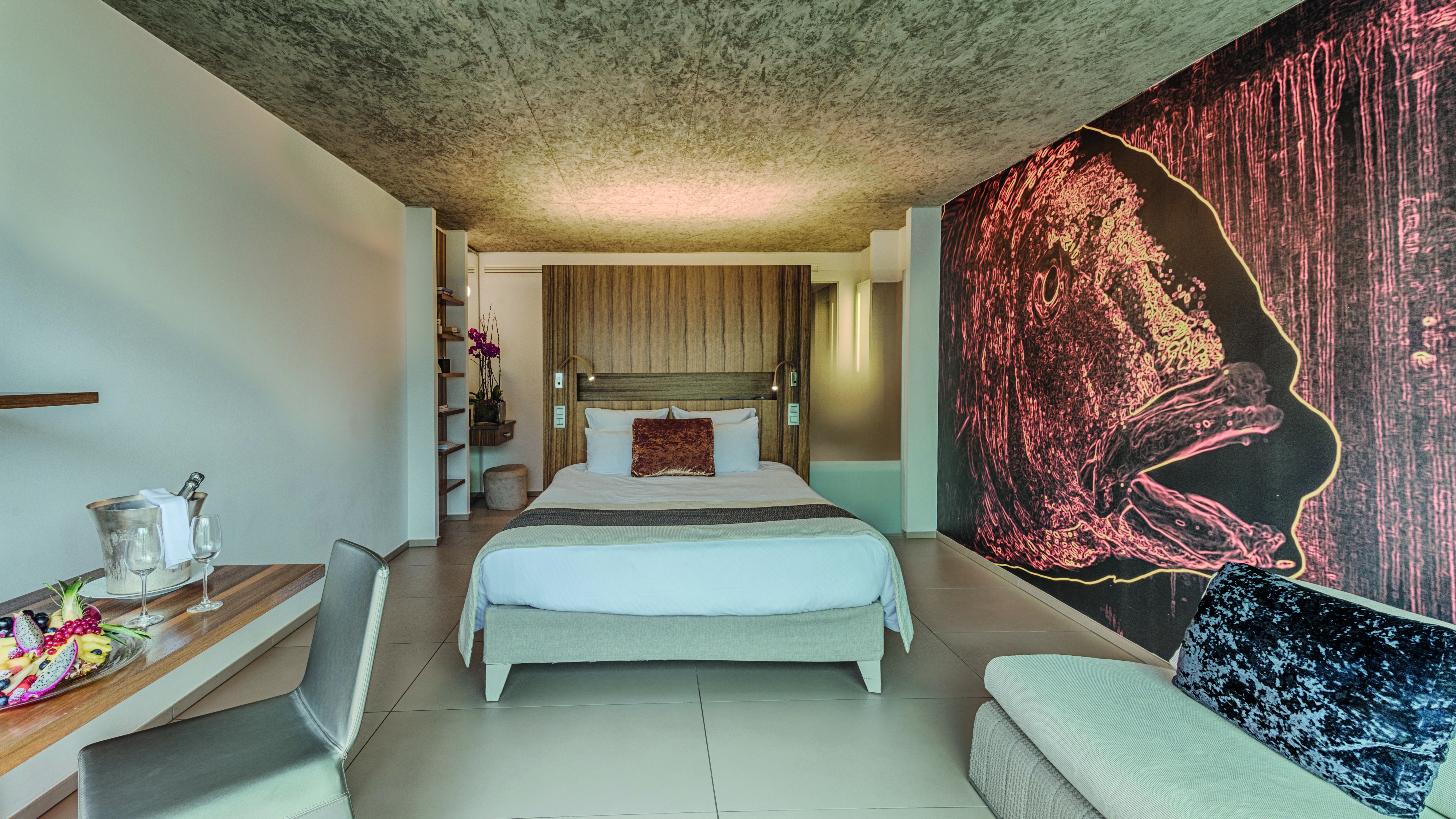 Le Cap d'Antibes Beach Hotel Cote d'Azur deluxe bedroom with desk and large painting of a fish on the wall
