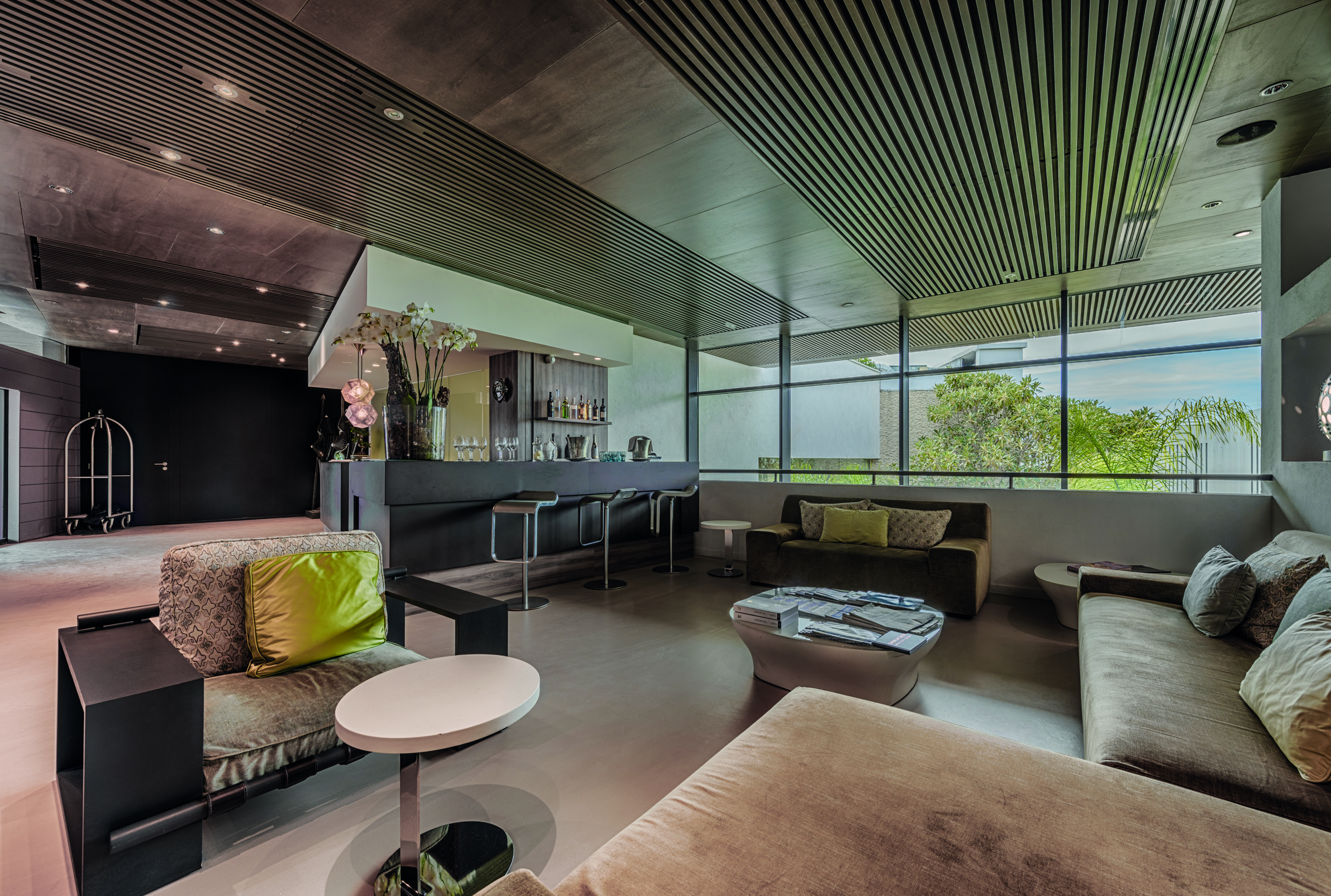 Le Cap d'Antibes Beach Hotel Cote d'Azur lobby area with sofas and armchairs and a small bar area