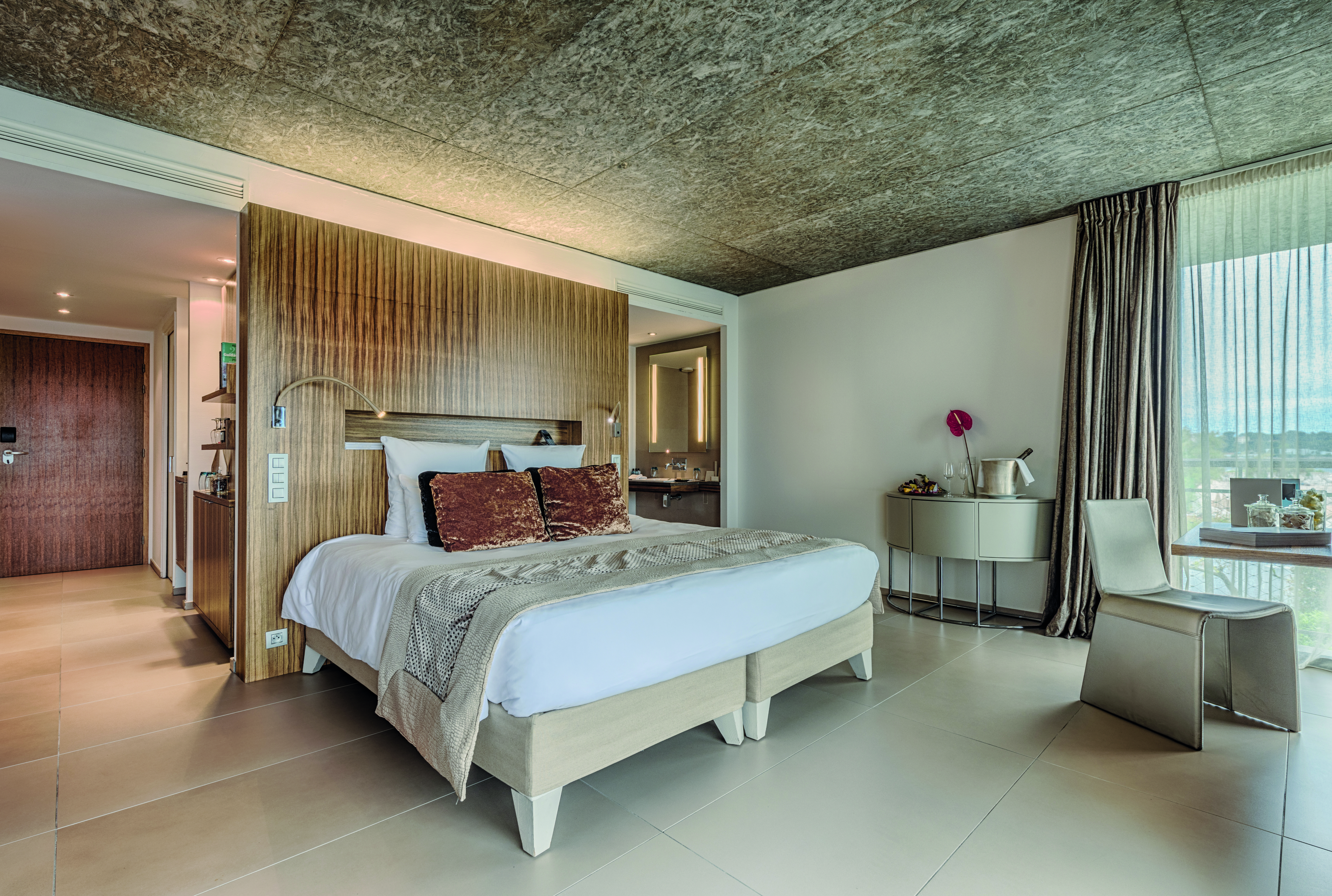 Le Cap d'Antibes Beach Hotel Cote d'Azur suite bedroom with desk chair and view into second room