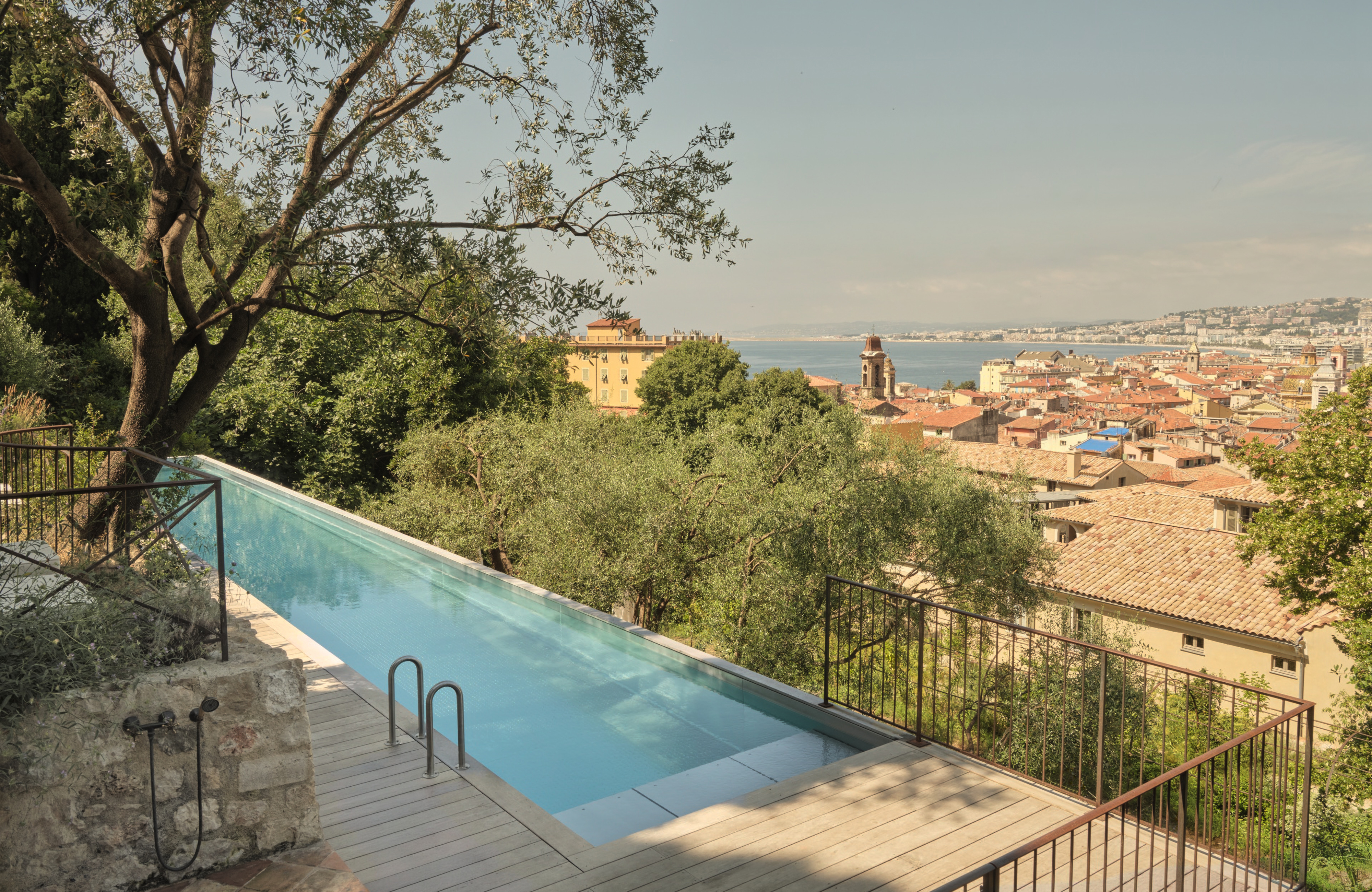 Hotel du Couvent long, thin pool with an infinity edge, looking over the city of Nice and the sea beyond