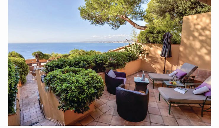 Hotel La Perouse Nice terrace patio walled terrace with two sun loungers a small table and two chairs
