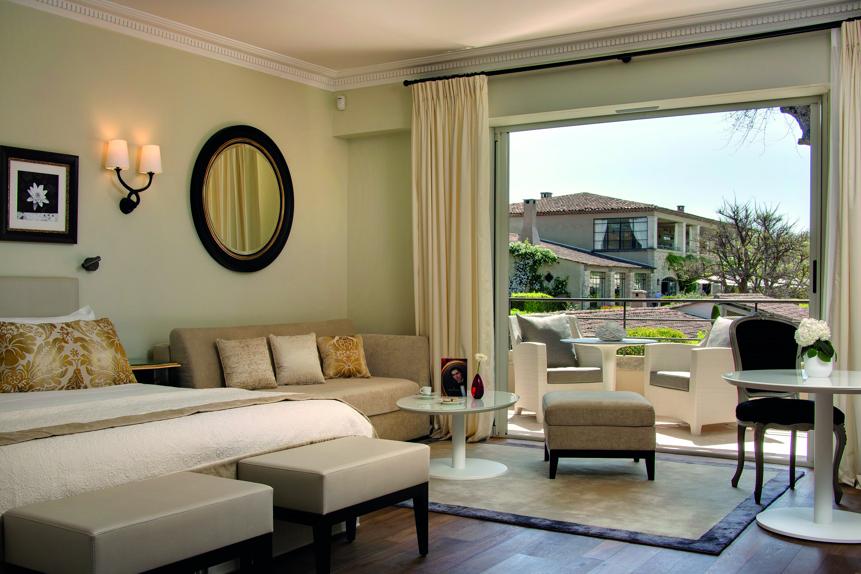 Le Mas de Pierre Cote d'Azur junior suite bedroom sofa tables and balcony view