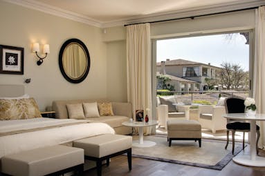 Le Mas de Pierre Cote d'Azur junior suite bedroom sofa tables and balcony view