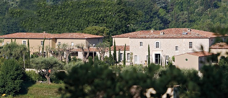 Le Mas de Pierre Cote d'Azur outside building large stone buildings with terracotta rooves in front of a wooded hillside