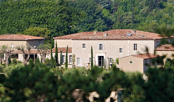 Le Mas de Pierre Cote d'Azur outside building large stone buildings with terracotta rooves in front of a wooded hillside