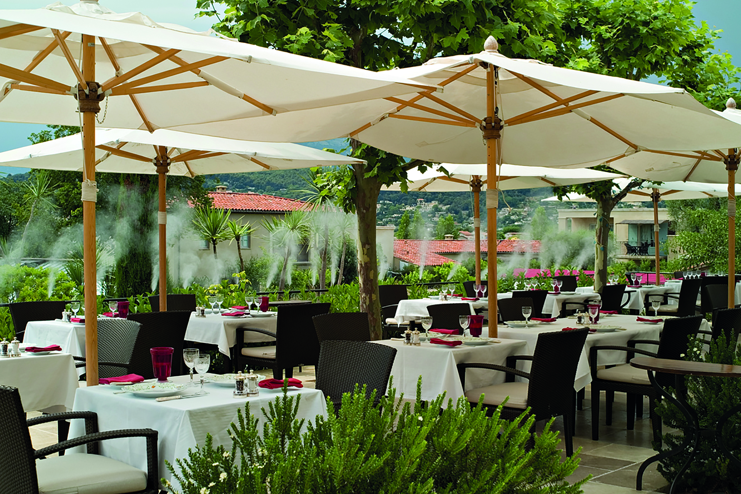 Le Mas de Pierre Cote d'Azur seated terrace outdoor dining area with large umbrellas