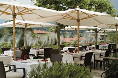 Le Mas de Pierre Cote d'Azur seated terrace outdoor dining area with large umbrellas