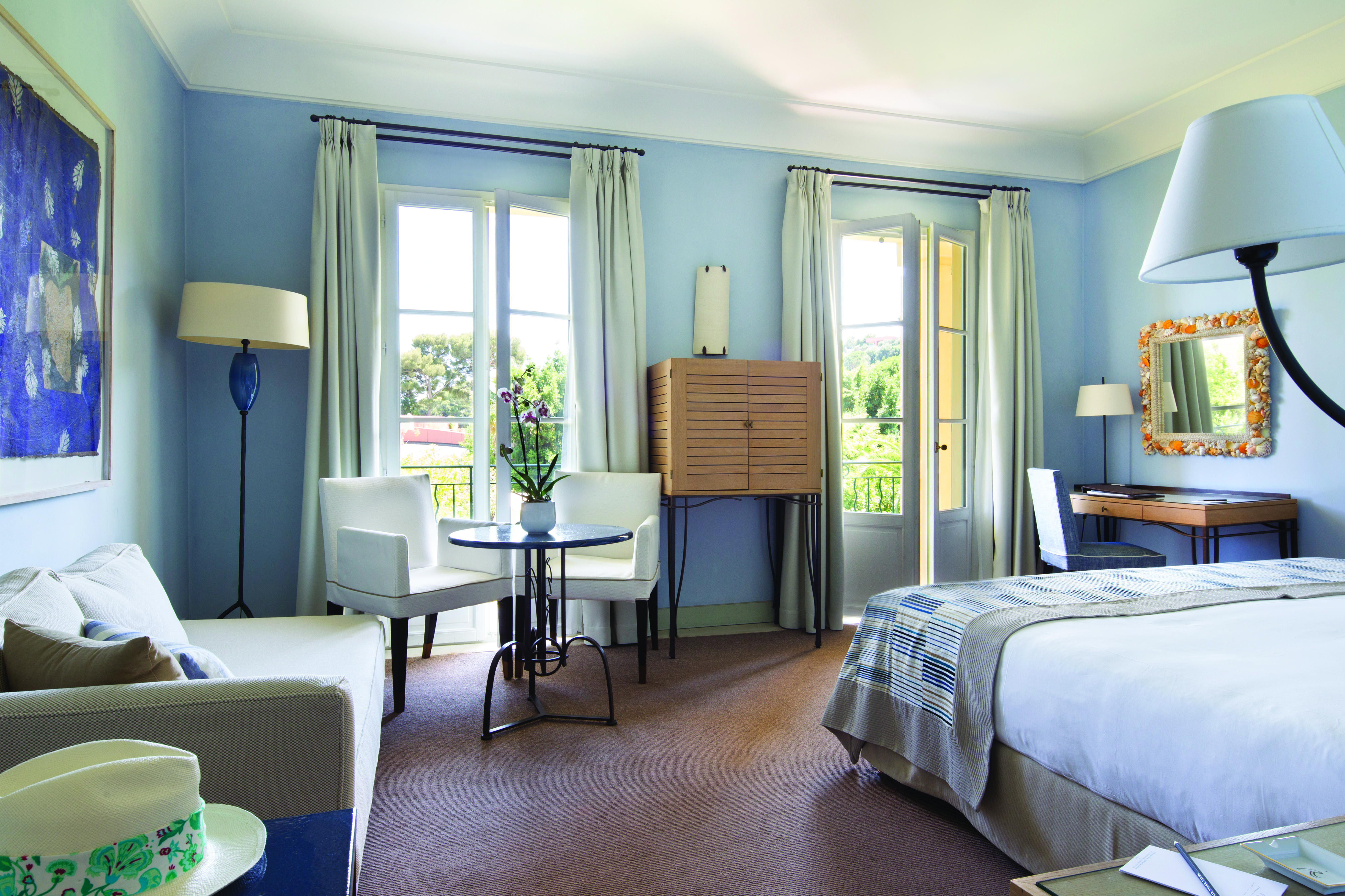 Royal Riviera Cote d'Azur deluxe bedroom with sofa table and chairs and writing desk