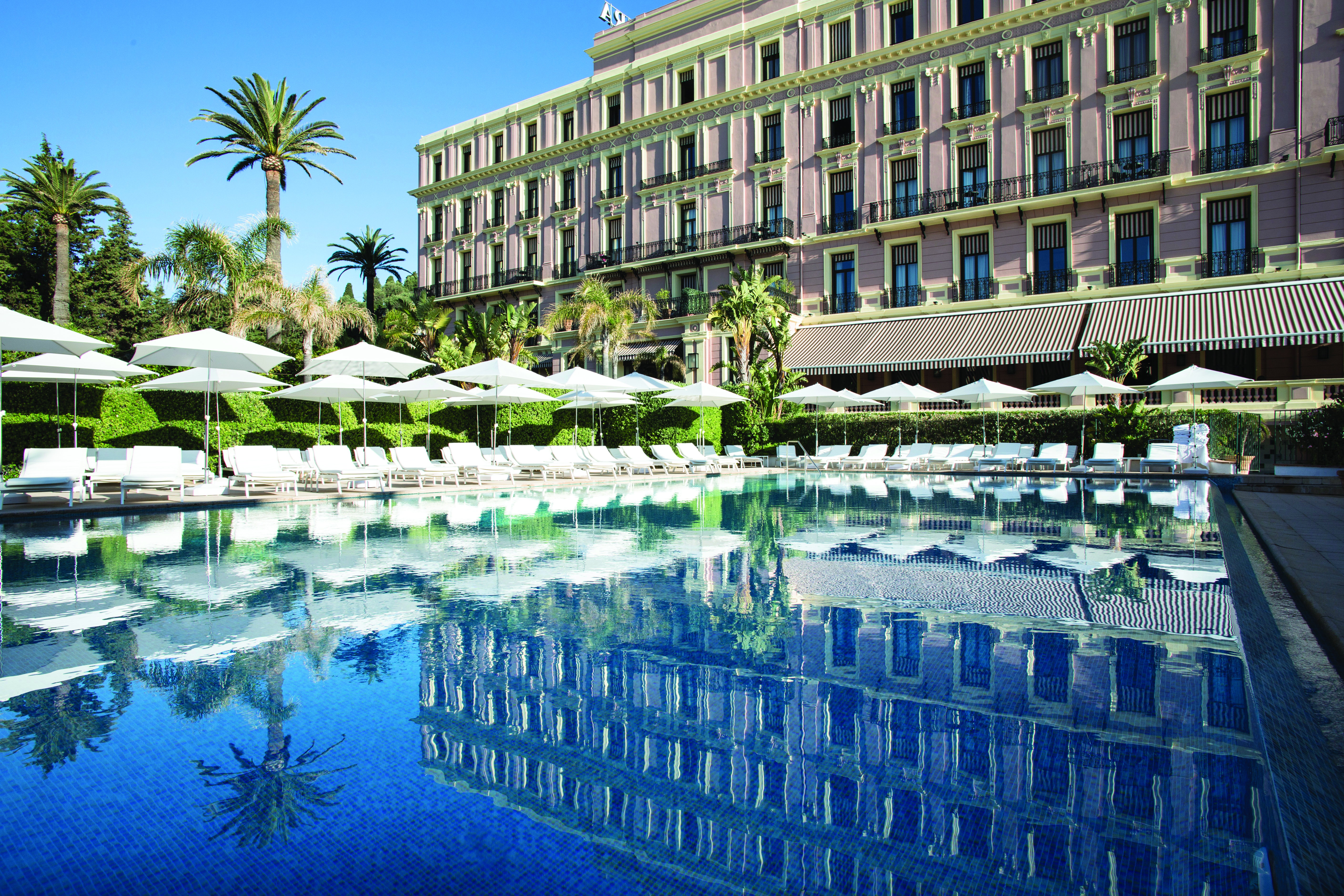 Royal Riviera Cote d'Azur outdoor swimming pool large pink building with balconies