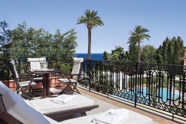 Royal Riviera Cote d'Azur suite balcony wrought iron fence sun loungers table and chairs