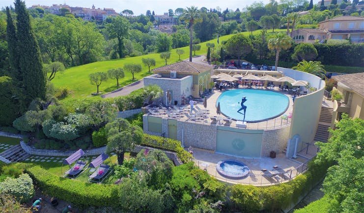Le Mas Candille Cote d'Azur outdoor pool aerial view of a stone building and large round swimming pool