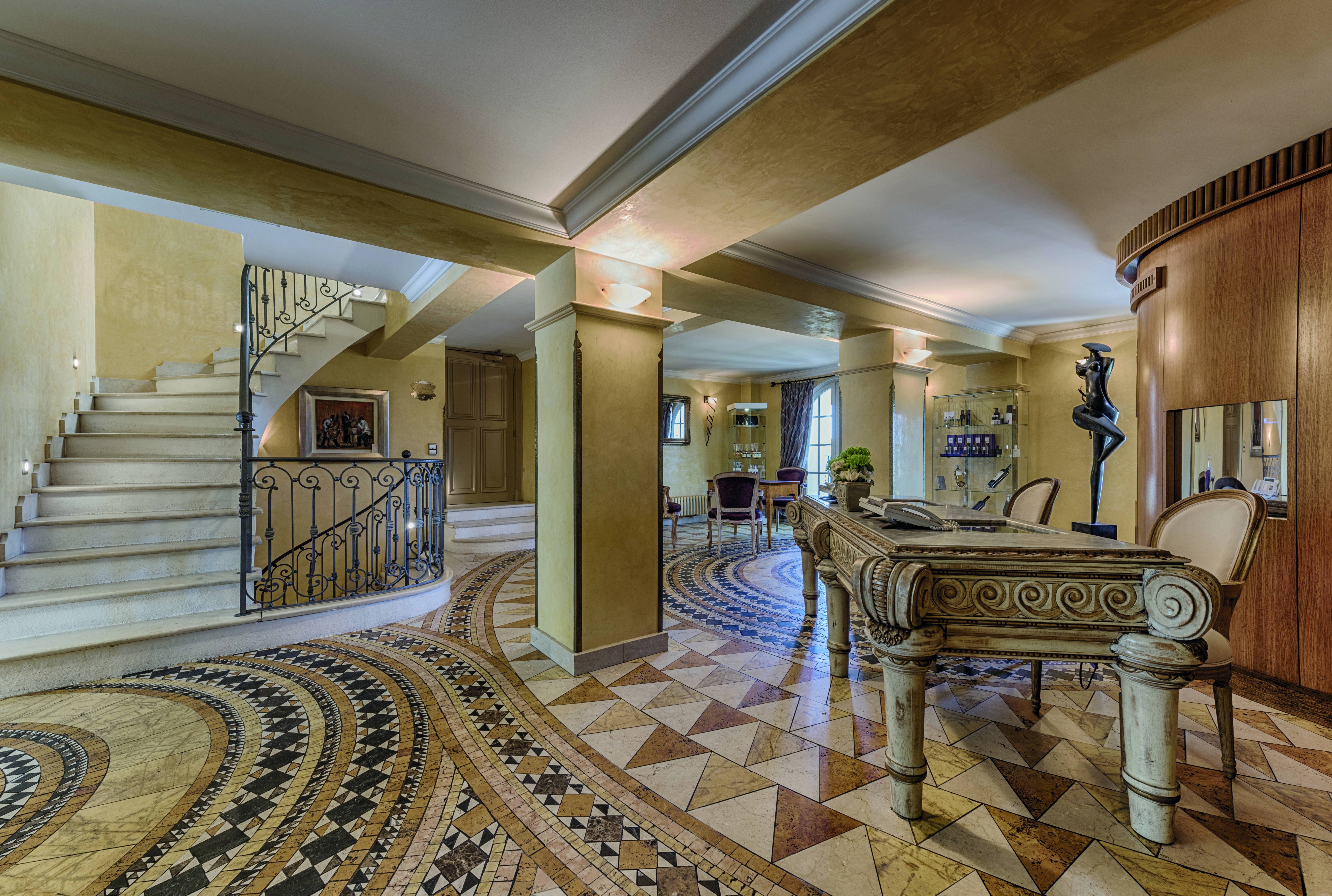 Le Mas Candille Cote d'Azur reception area with mosaic tiled floors large stone table and stairs