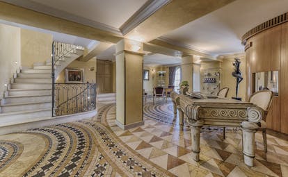 Le Mas Candille Cote d'Azur reception area with mosaic tiled floors large stone table and stairs