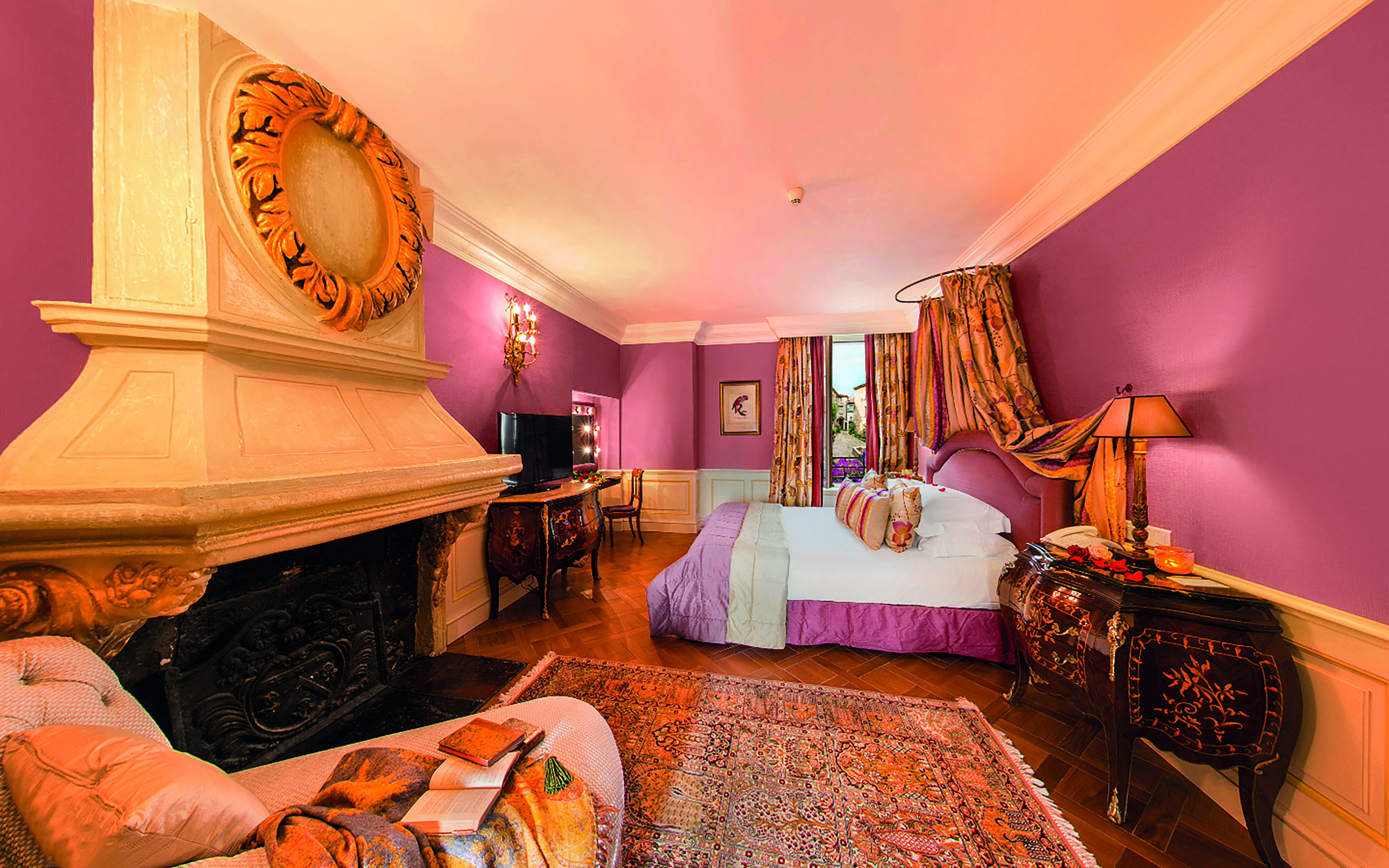 Le Saint Paul Cote d'Azur pink bedroom with fireplace