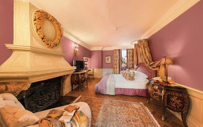 Le Saint Paul Cote d'Azur pink bedroom with fireplace