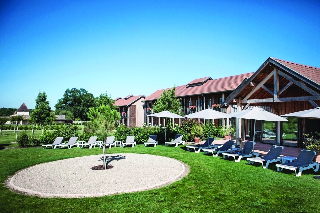 Chateau des Vigiers Dordogne relais outdoor wooden building sun loungers and umbrellas