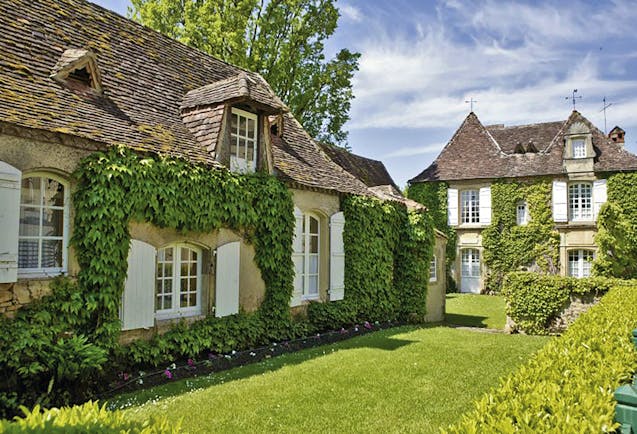 Le Vieux Logis Dordogne outdoor exterior two foliage covered buildings with white shuttered windows