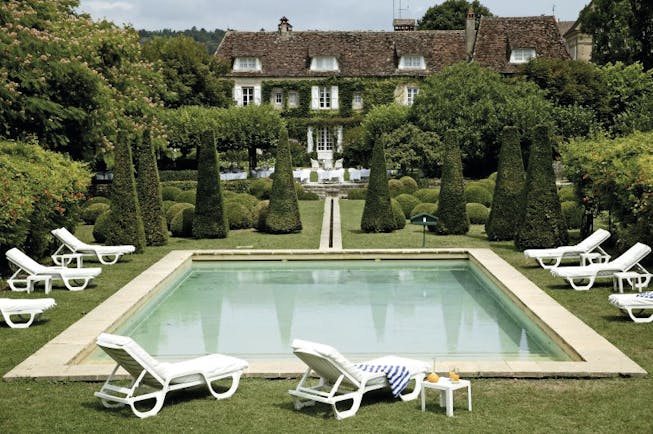 Le Vieux Logis Dordogne outdoor swimming pool sun loungers and topiary trees