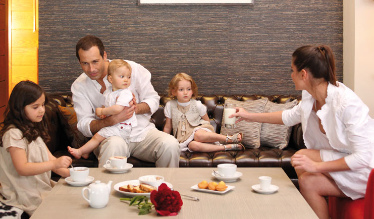Hotel Ermitage Alps family dining on sofa 