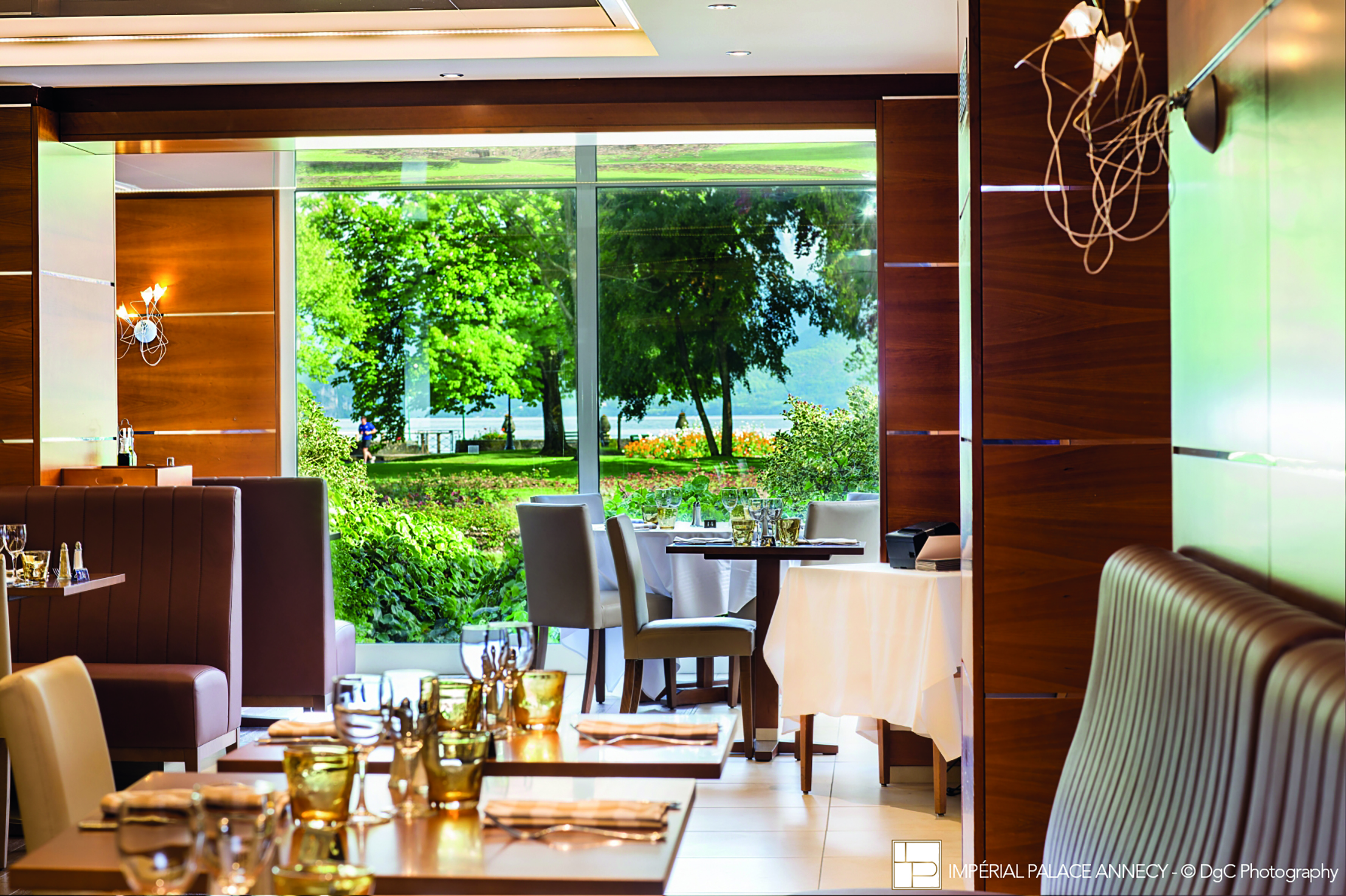 L'Imperial Palace Alps brasserie restaurant with view of trees and lake