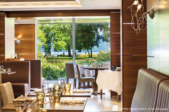 L'Imperial Palace Alps brasserie restaurant with view of trees and lake