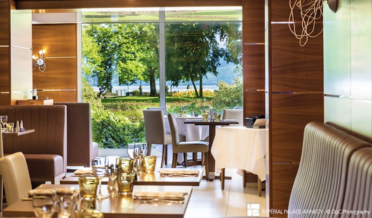 L'Imperial Palace Alps brasserie restaurant with view of trees and lake