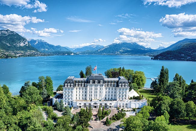 L'Imperial Palace Alps lake aerial shot hotel woods near a lake