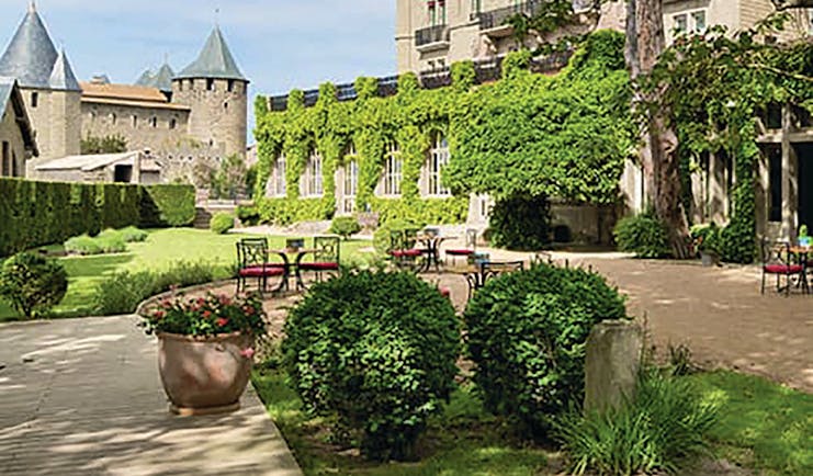 Hotel de la Cite Carcassonne Languedoc Roussillon exterior chateau and white building garden and seating area