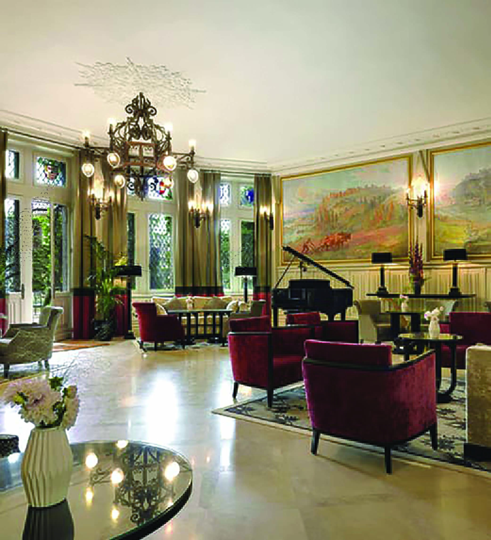 Hotel de la Cite Carcassonne Languedoc Roussillon lounge area with armchairs a grand piano and paintings