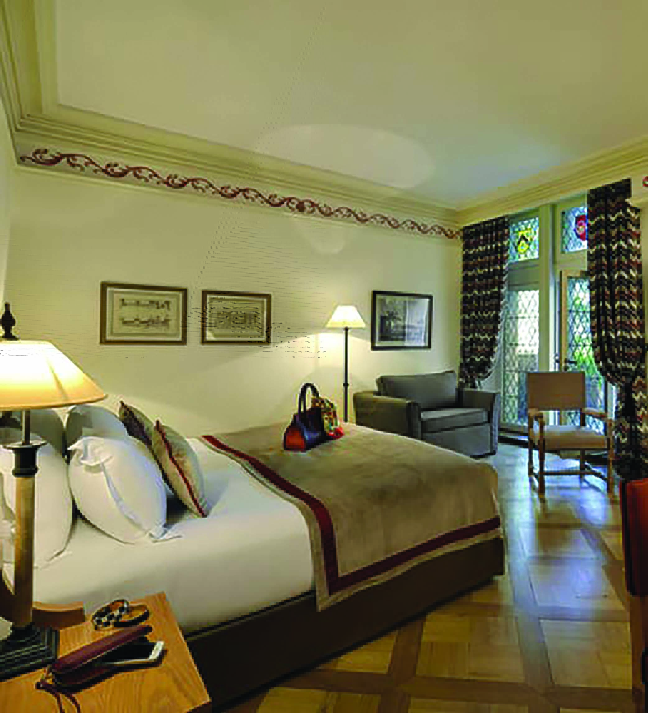 Hotel de la Cite Carcassonne Languedoc Roussillon suite bedroom with armchair chair and stained-glass window